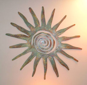 Bronze sun on light-colored background